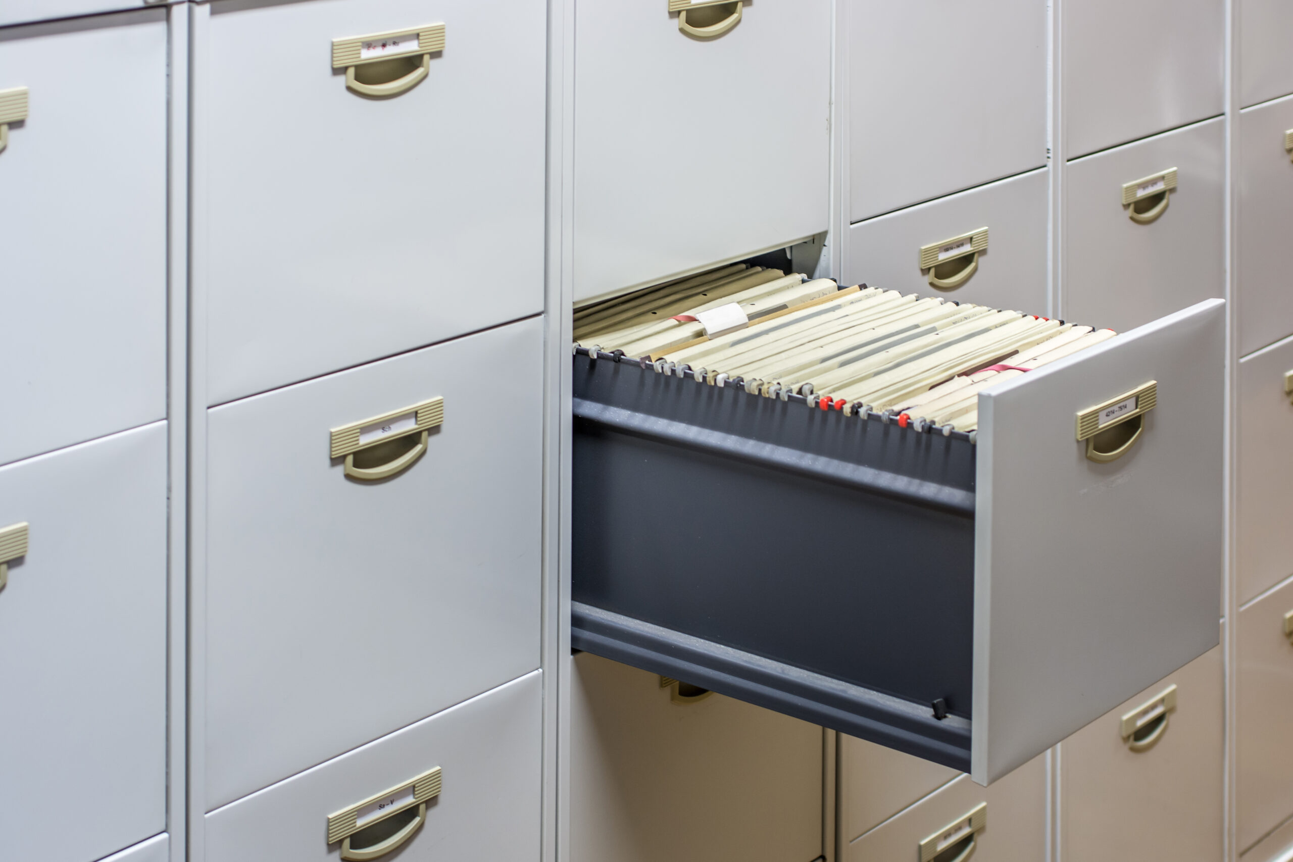 File cabinet with a wide open drawer full of files